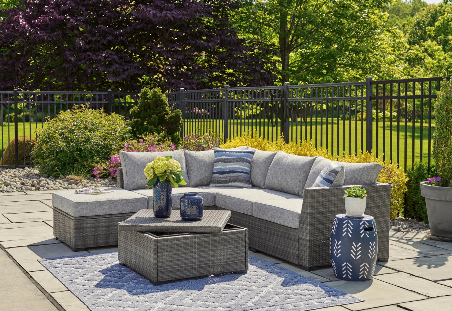 Signature Design by Ashley Petal Road Casual Nuvella Weather Resistant Fabric, Cushioned Outdoor Loveseat Sectional/Ottoman/Table Set with 2 Throw Pillows, Set of 4, Gray